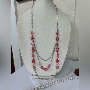 Long silvertone necklace with peachy pink beads